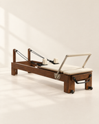 The Pavilion Reformer in walnut with cream upholstery