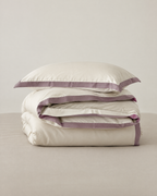 The Lyon Silk Bedding Set in cream with mauve border, folded