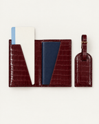 The Grand Voyage Travel Set in Croc Burgundy, open with passport and ticket