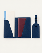 The Grand Voyage Travel Set in Cross-grain Navy, open with passport and ticket