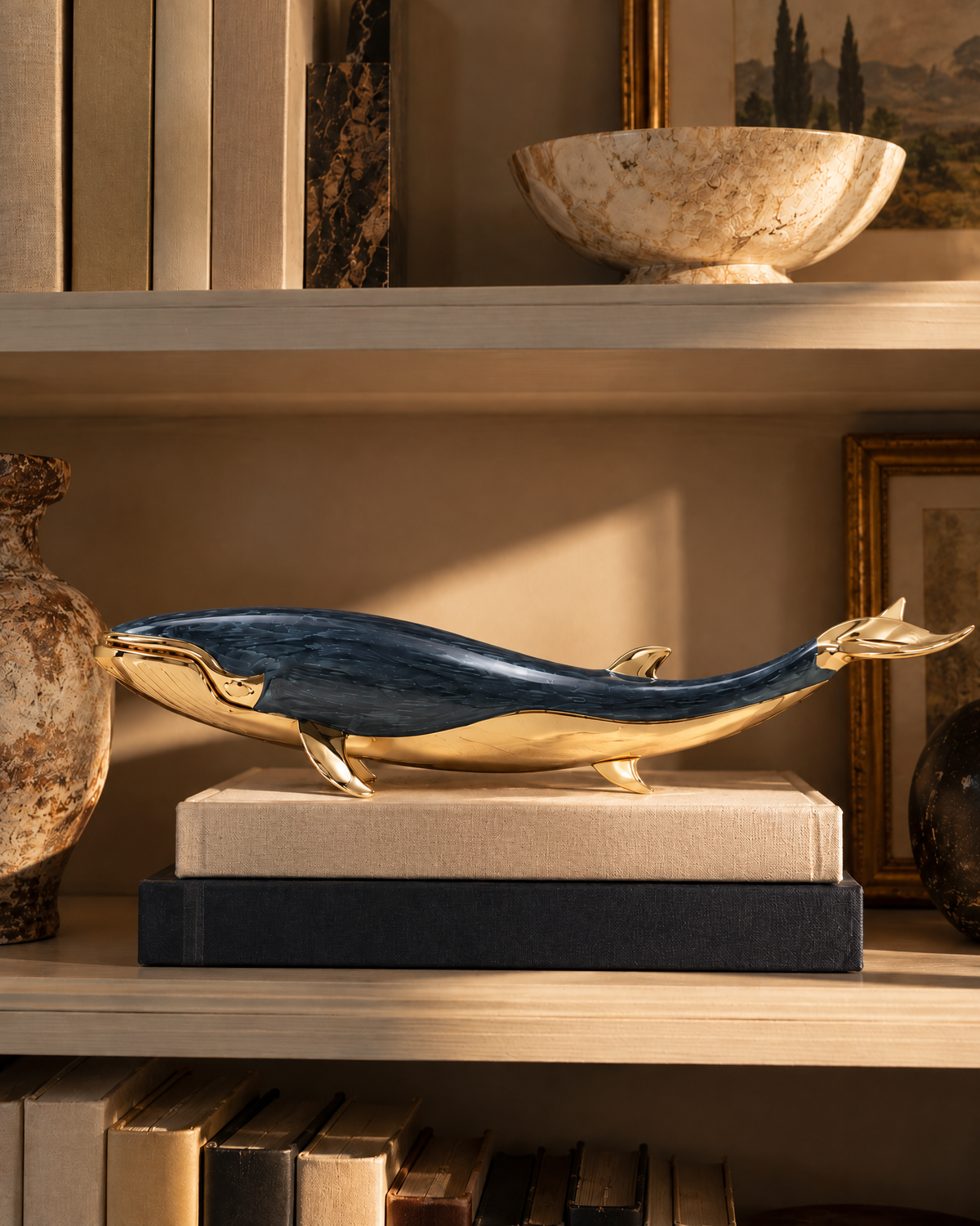 The Nantucket Whale on a stack of books on a bookshelf