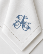 The Belle Époque Napkin, close-up of an embroidered floral initial on a hemstitched napkin corner
