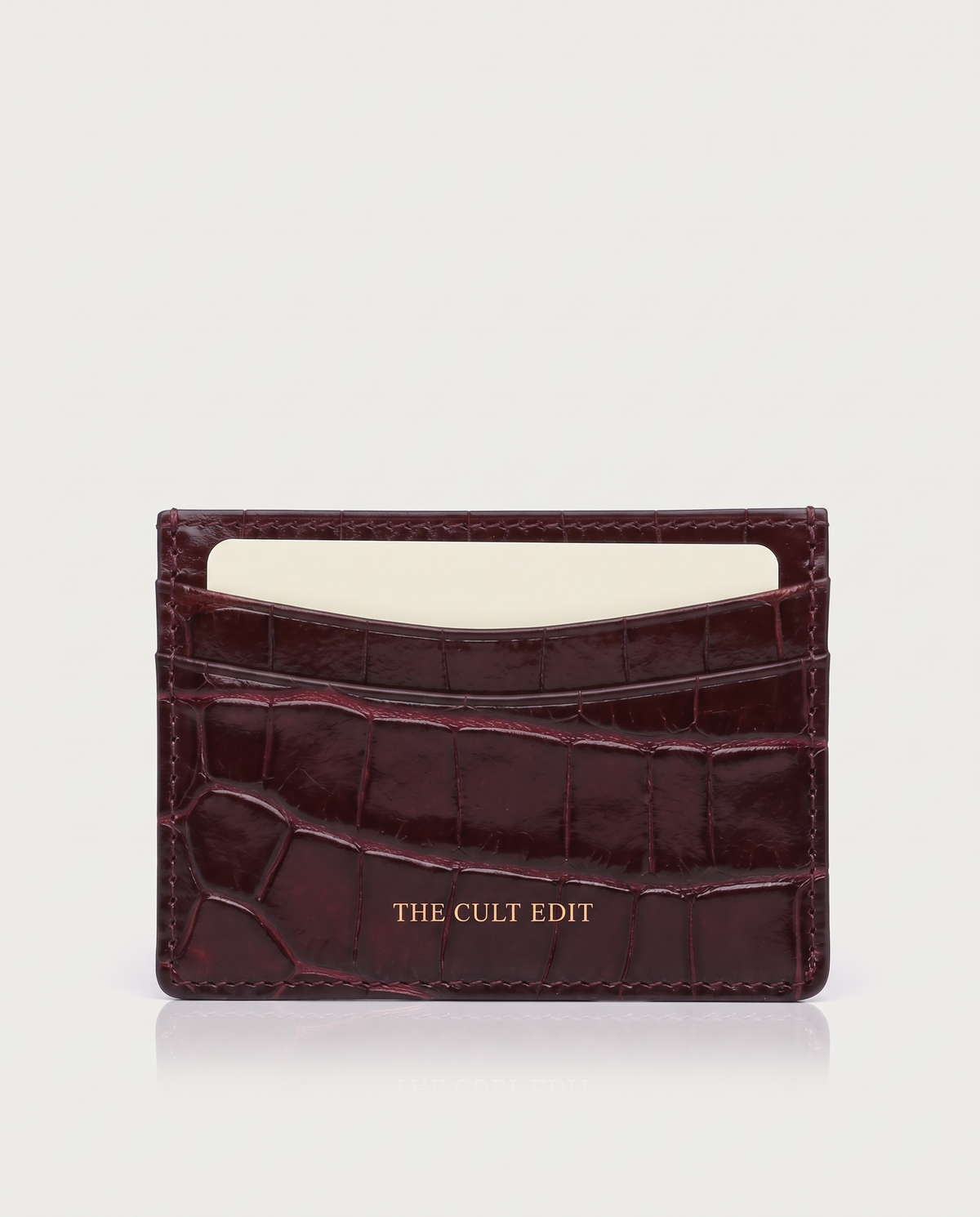The Savile Card Holder in Dark Burgundy croc-embossed leather with gold THE CULT EDIT lettering
