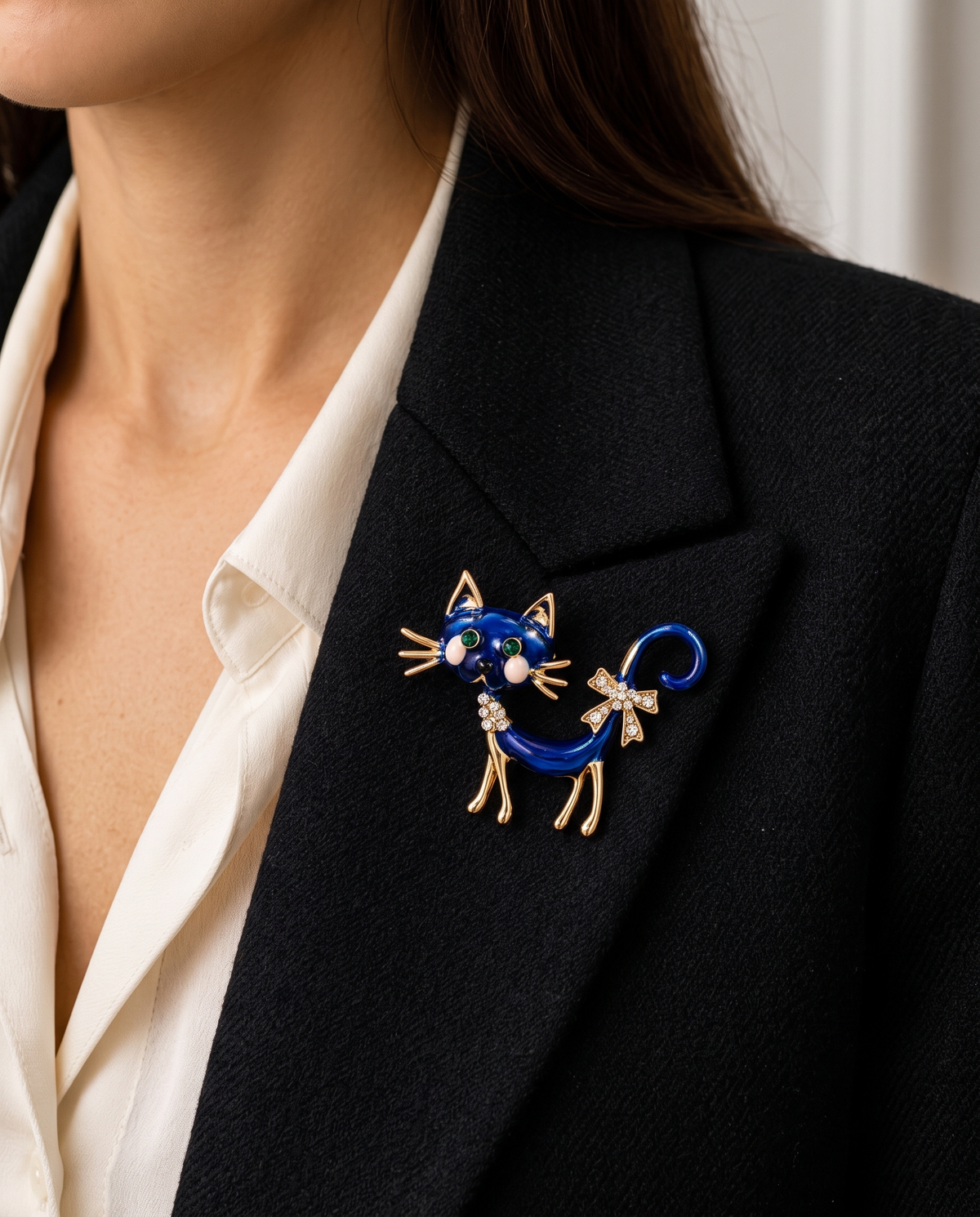 The Midnight Cat Brooch worn on the lapel of a black blazer