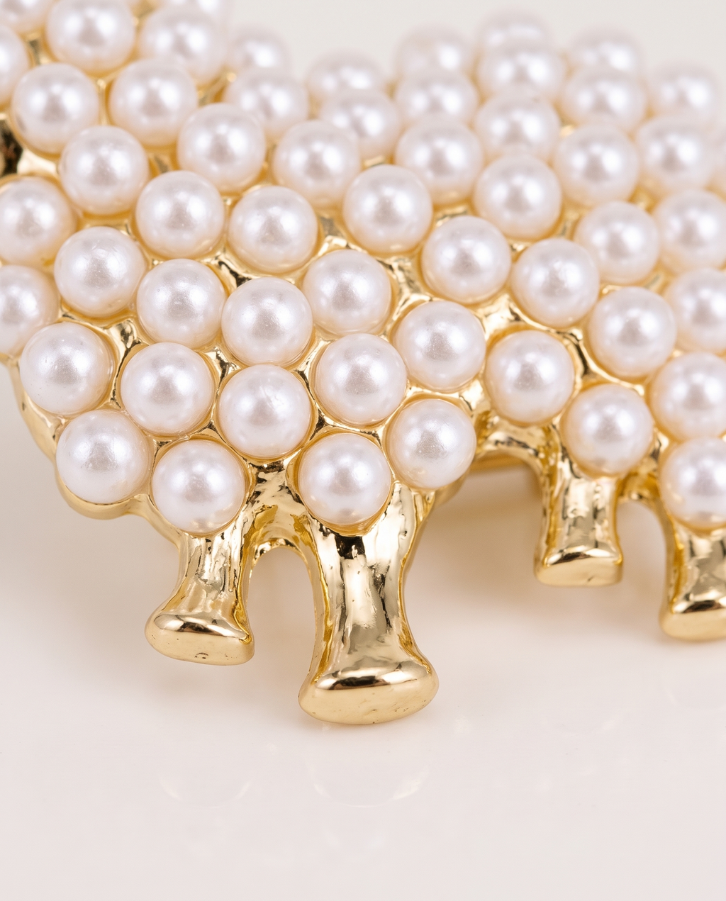 Close up of the pearl beads and gold legs