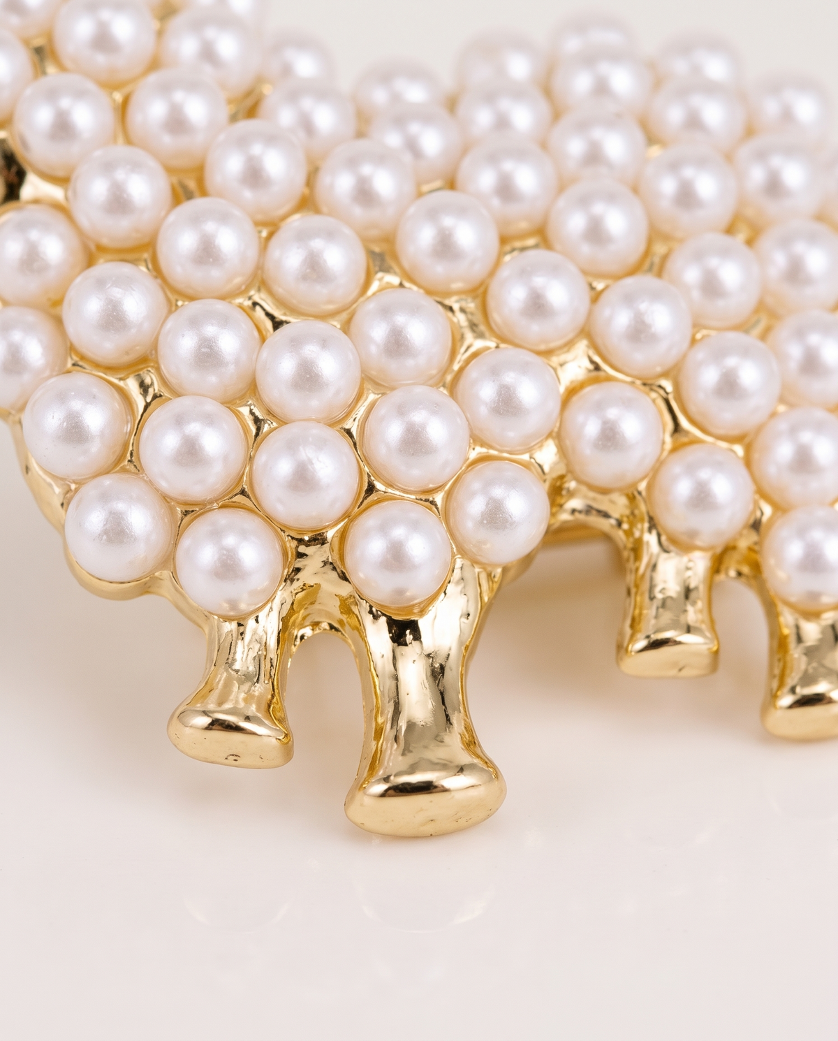 Close up of the pearl beads and gold legs