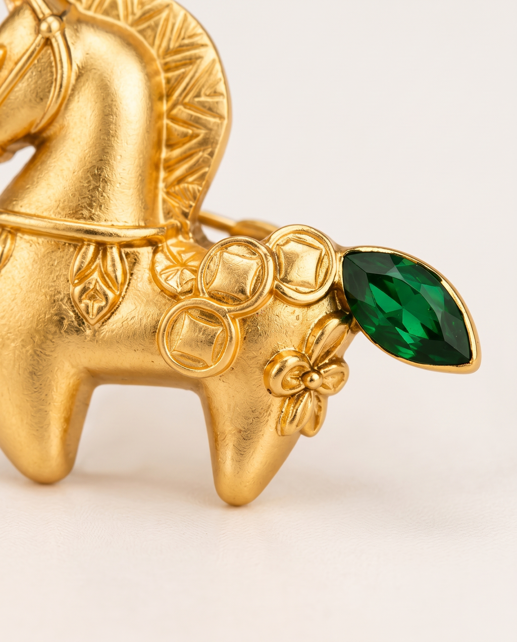 Close up of the coin motifs and green crystal tail