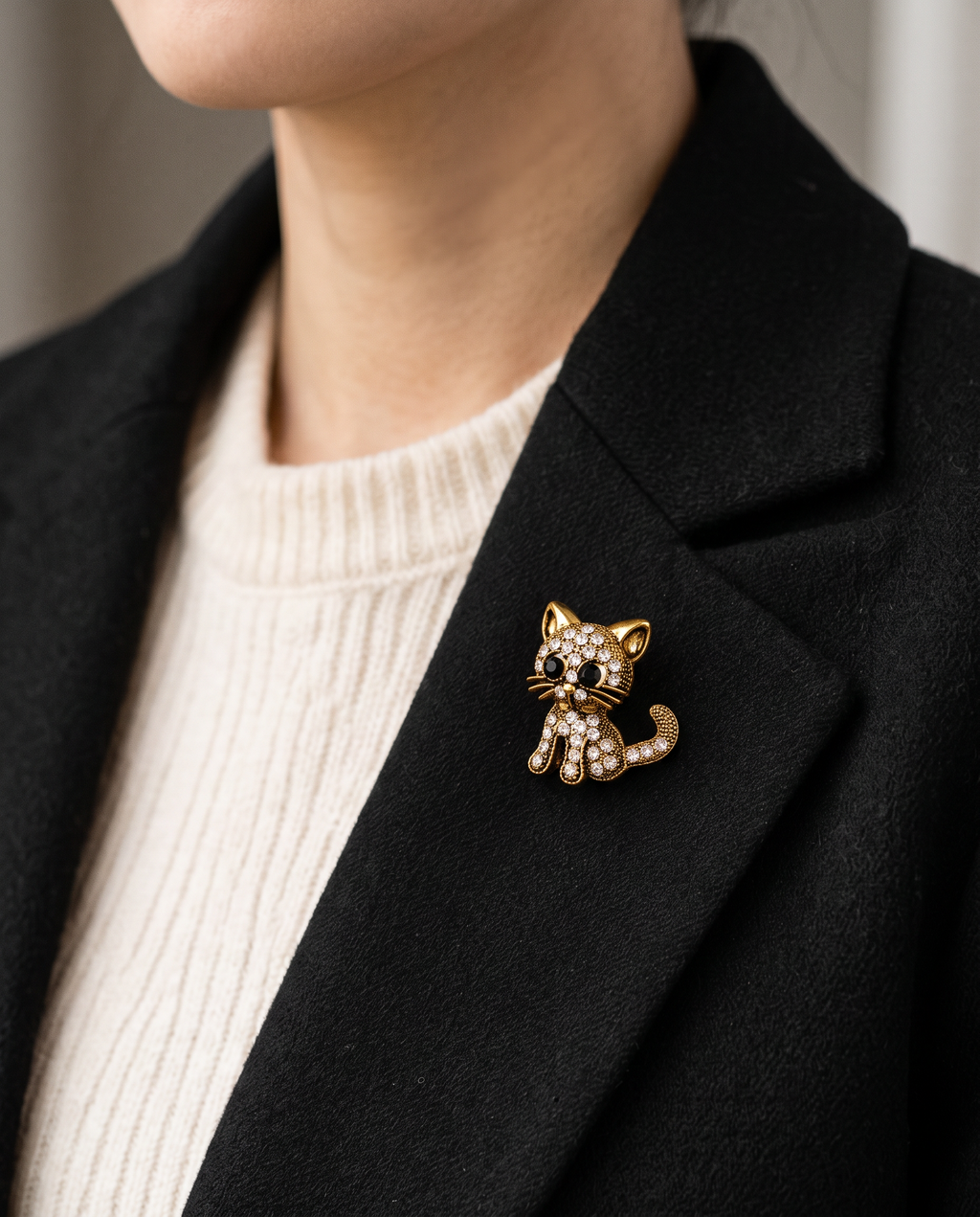 The Diamante Cat Brooch worn on the lapel of a black blazer
