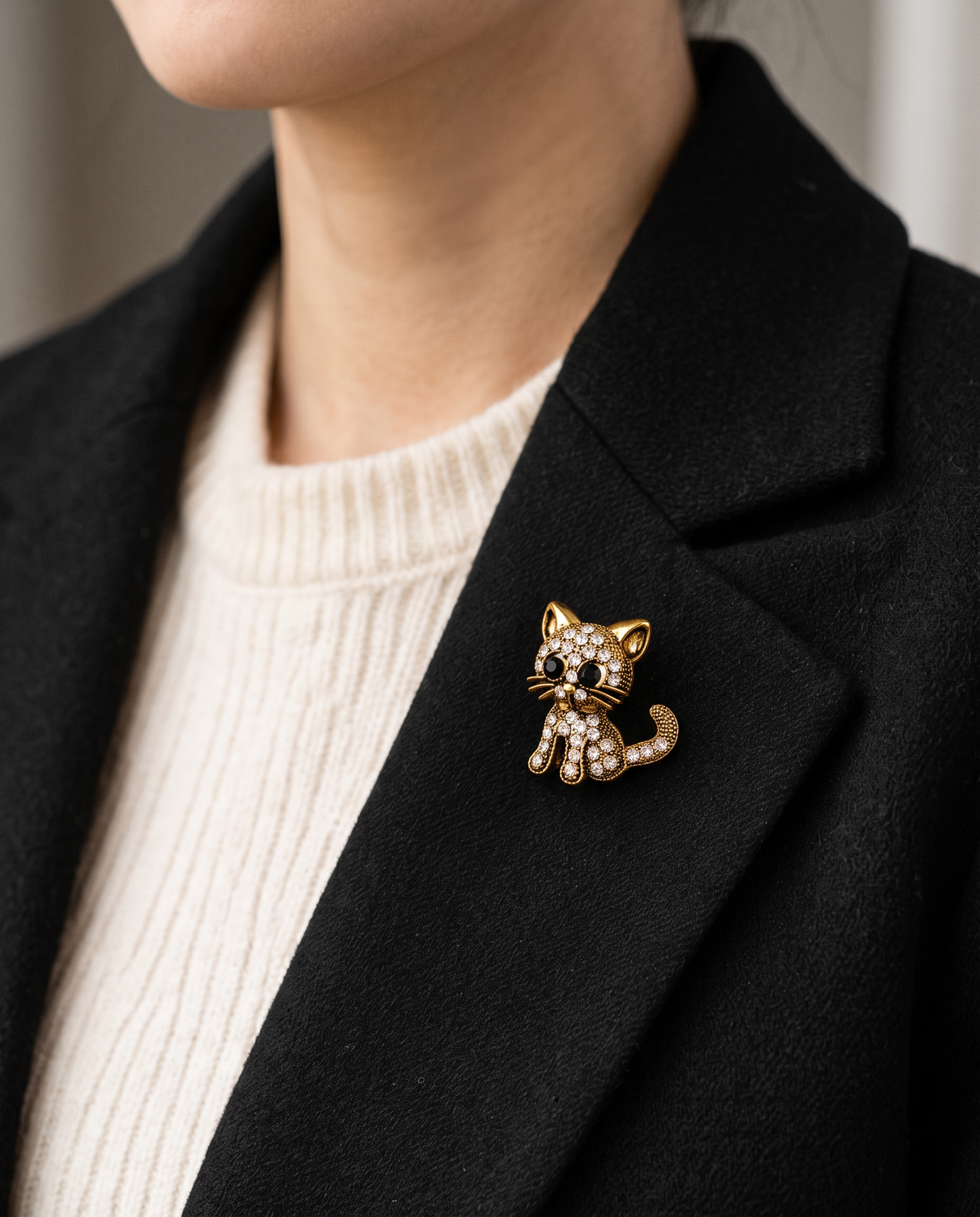 The Diamante Cat Brooch worn on the lapel of a black blazer
