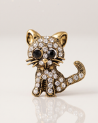 The Diamante Cat Brooch standing with a soft reflection