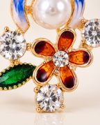 Close up of the enamel flower, crystals and green leaf