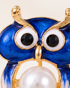 Close up of the blue enamel owl face