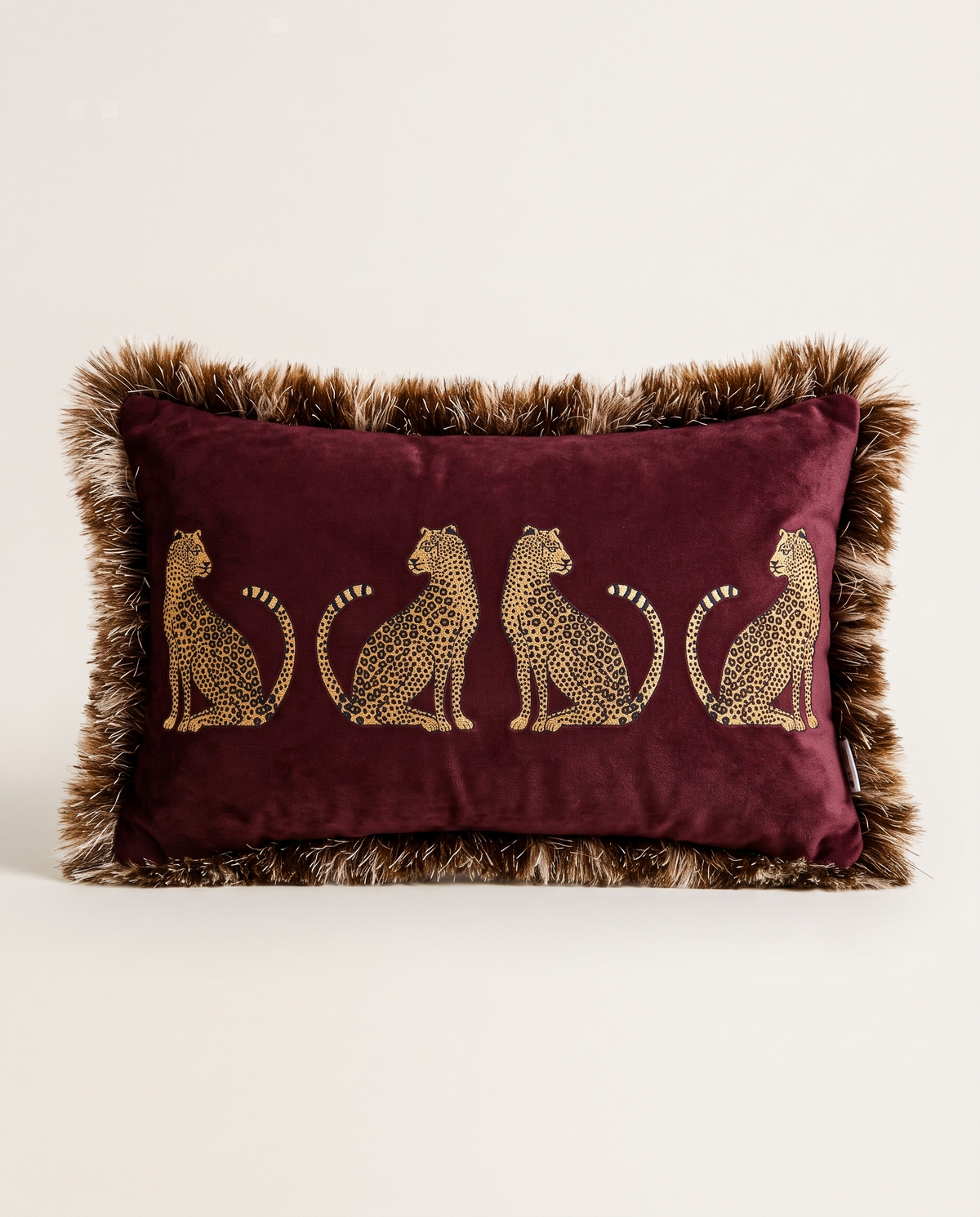 The Cheetah Parade Cushion in burgundy velvet