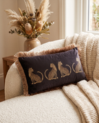 The black Cheetah Parade Cushion on a cream armchair