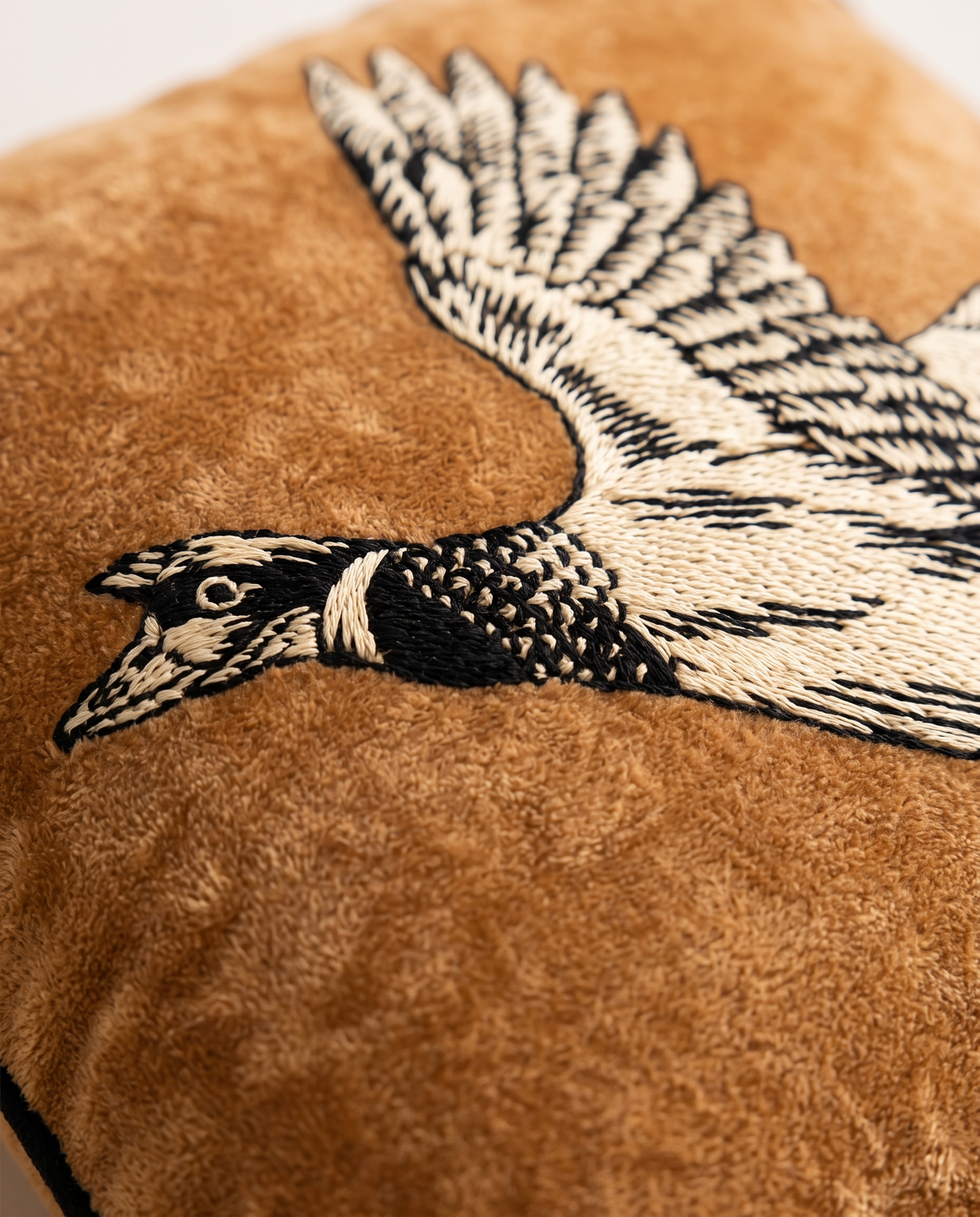 Close up of the embroidered goose on the reverse
