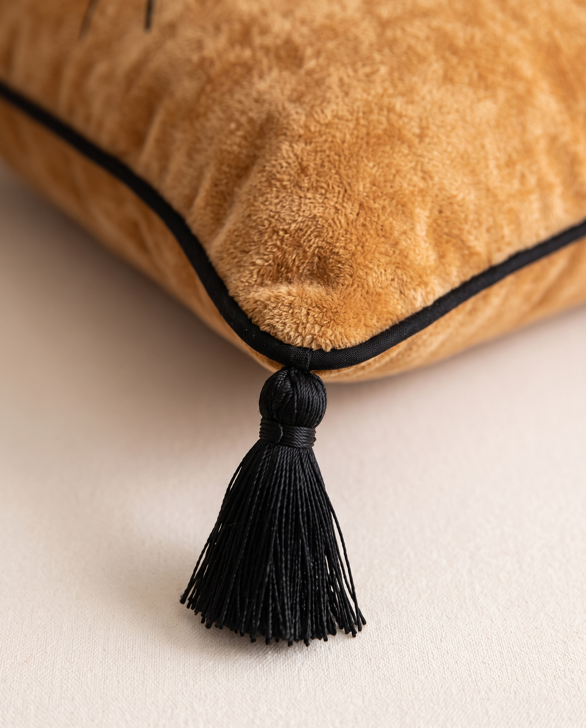 Black piping and corner tassel detail