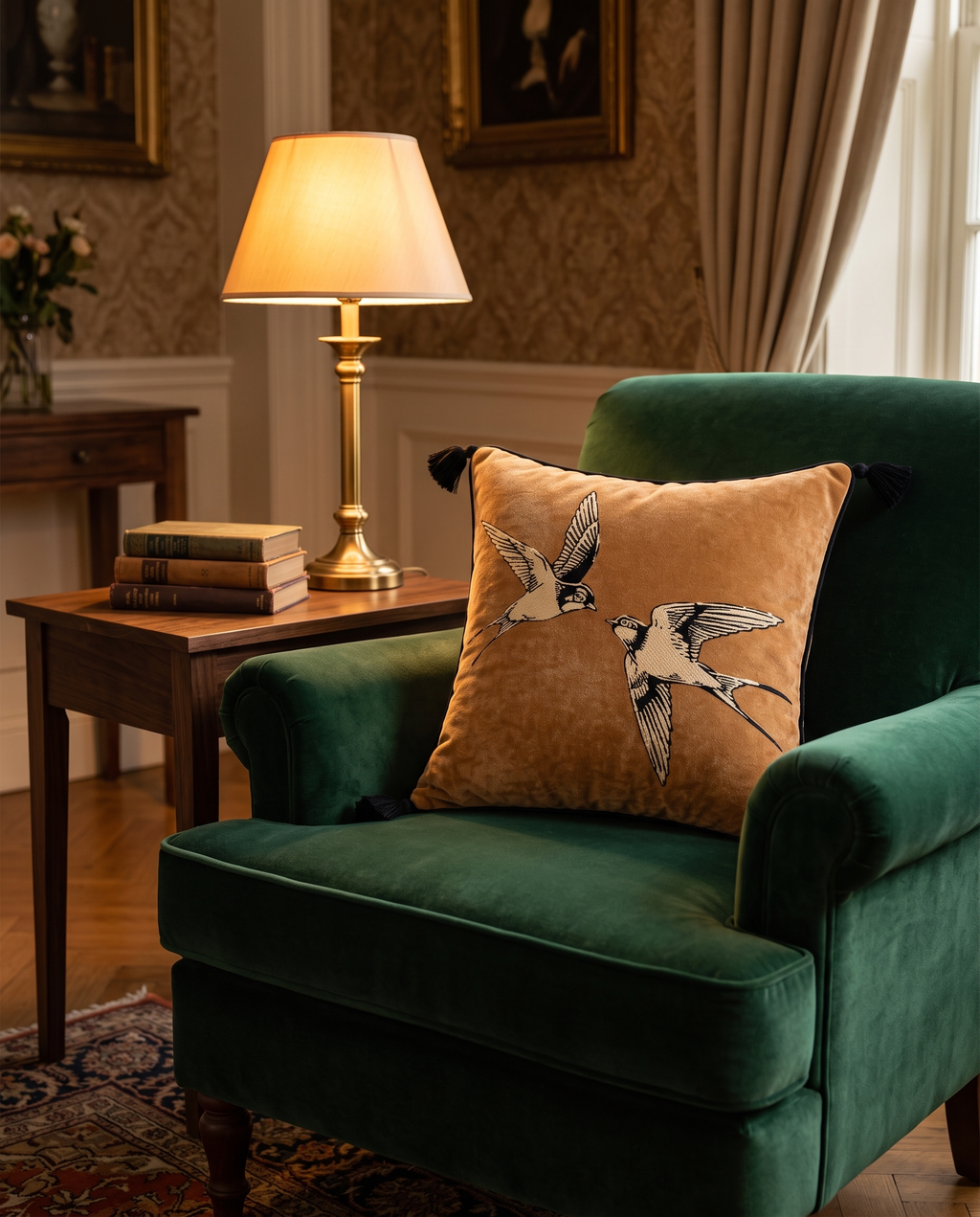 The Migration Cushion on a green velvet armchair