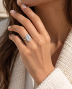 Hand wearing The Duchess Ring, a large oval stone on a slim silver band, with a cream boucle jacket