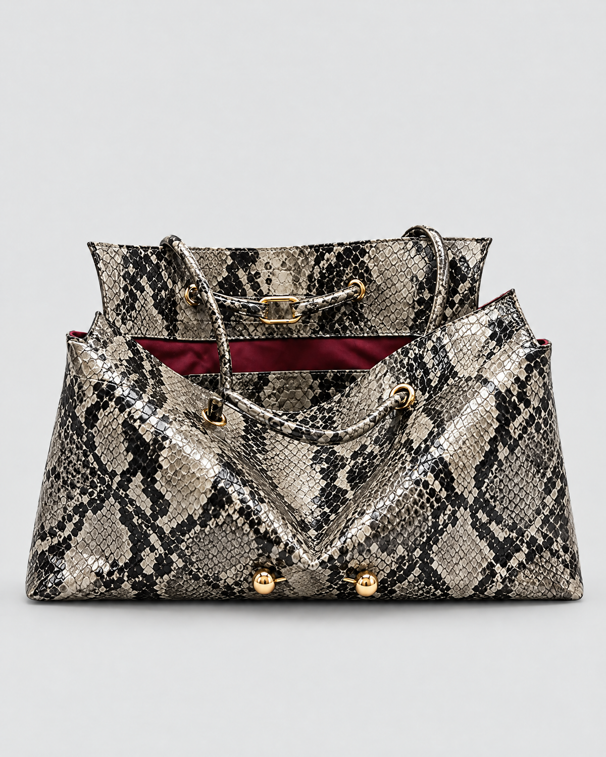 The Milano Tote in black python, open to show the inner panel and handles