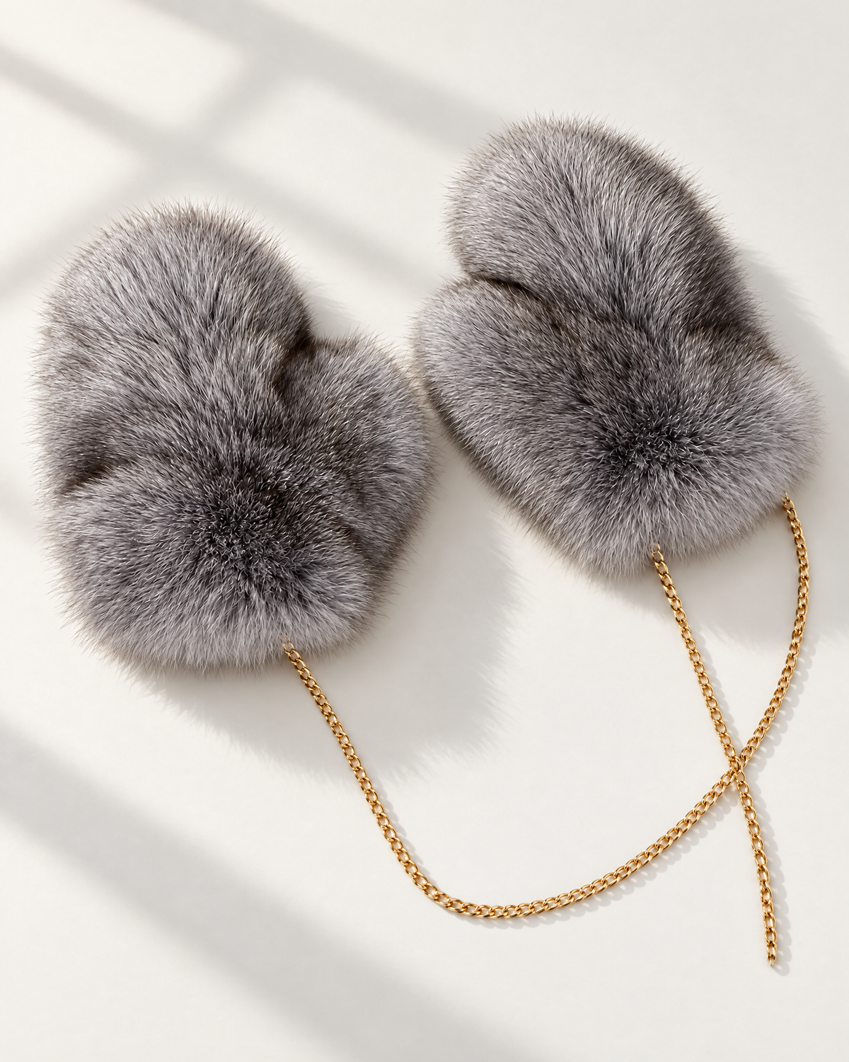 The St. Moritz Fur Mittens in grey fox fur on a gold chain