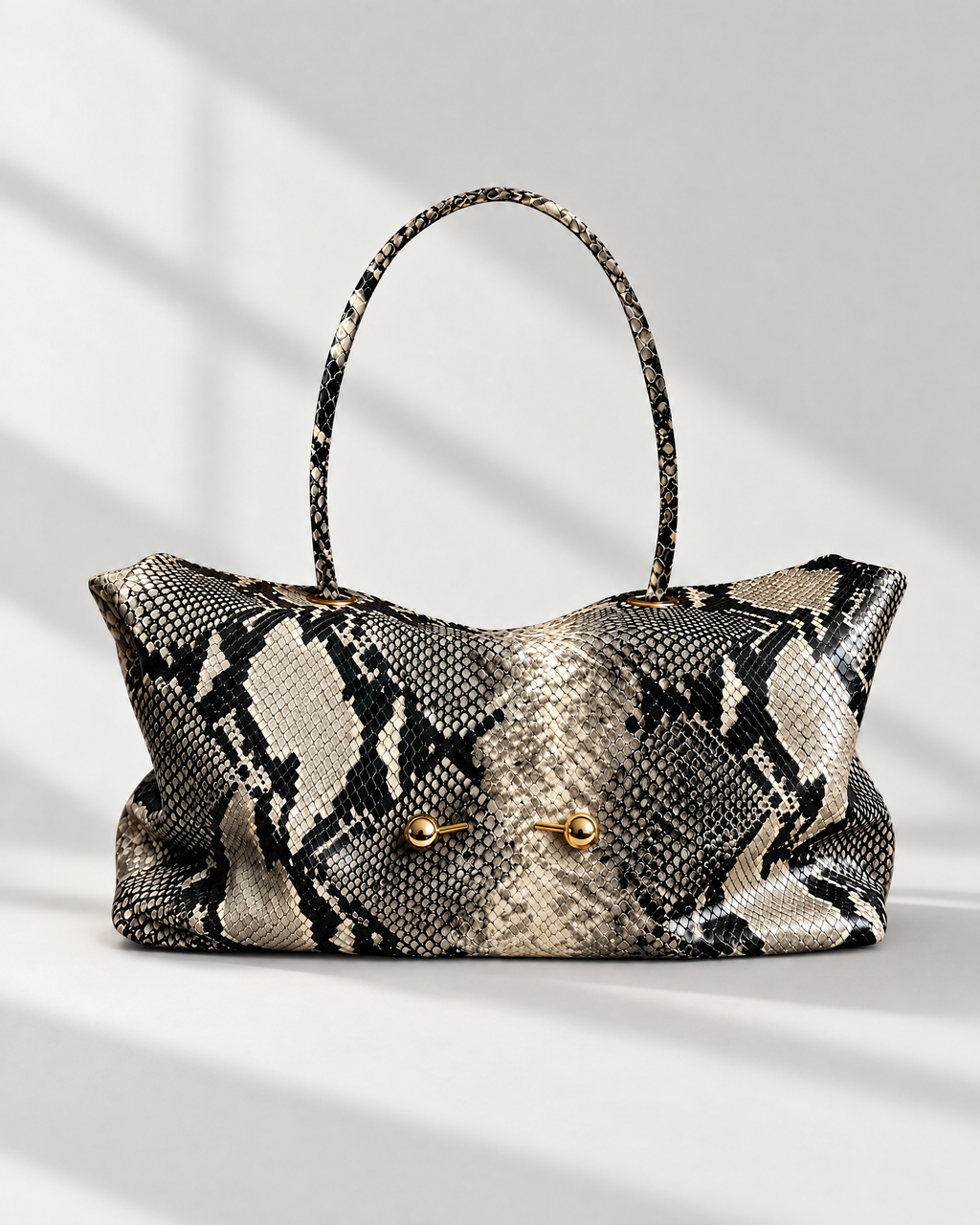 The Milano Tote in black python print with gold toggles