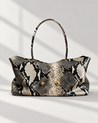 The Milano Tote in black python print with gold toggles