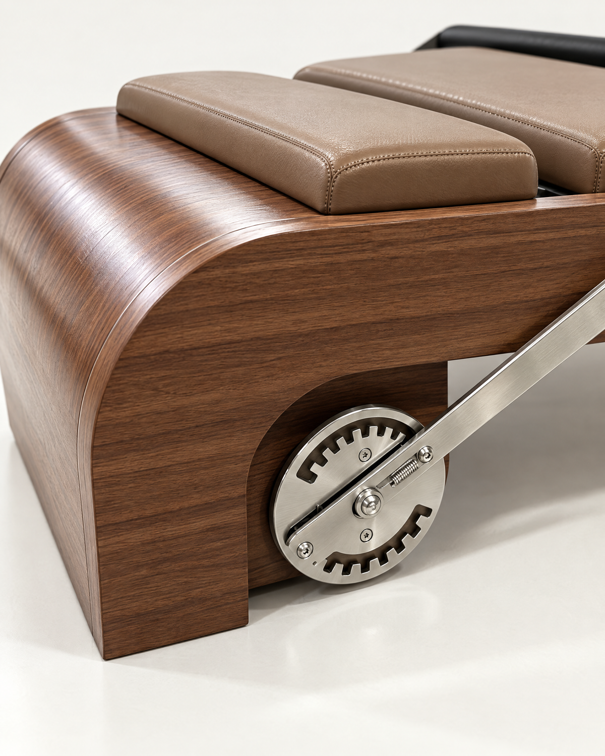 Curved walnut foot end and adjustable footbar mechanism of The Belgravia Reformer