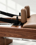 Tan leather carriage and shoulder rests of The Belgravia Reformer