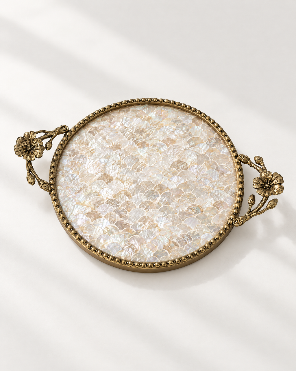 The Positano Tray in Shell mother of pearl with antique gold beaded rim and flower handles