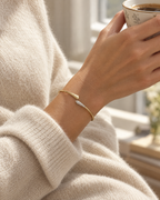 The Amalfi Cuff worn on the wrist with a cream cashmere jumper