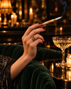 The Gatsby Cigarette Holder held at a candlelit cocktail bar