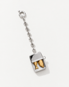 The Portofino Sardine Charm, a silver sardine tin with golden fish on a chain