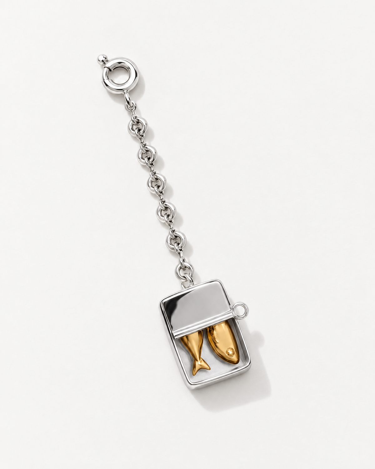 The Portofino Sardine Charm, a silver sardine tin with golden fish on a chain