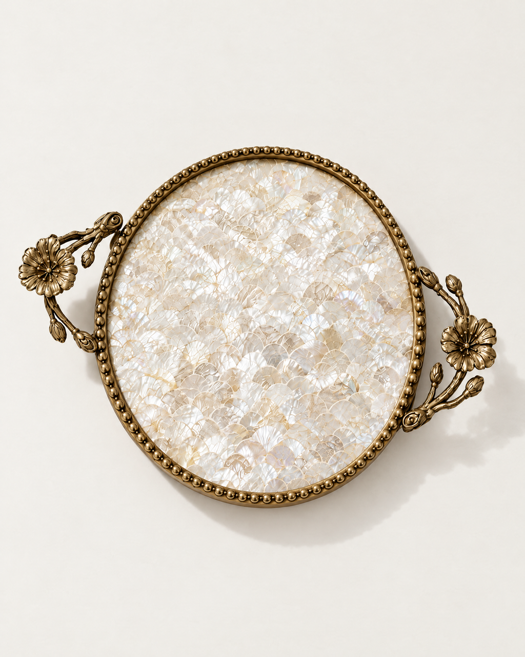 The Positano Tray in Shell mother of pearl with beaded brass rim and flower handles