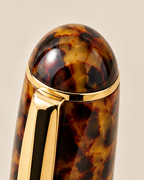 Domed tortoiseshell cap top