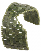 A wide, flexible woven cuff bracelet made of rectangular olive green stone tiles and small round beads, shown on a plain white background.